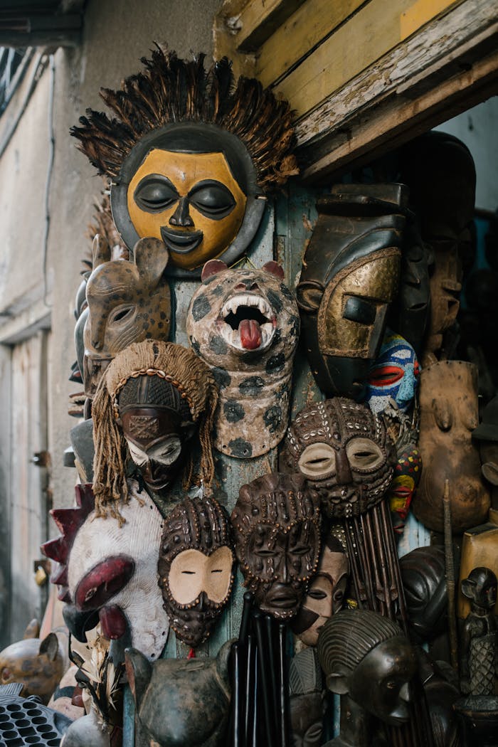A vibrant assortment of traditional masks displayed outside a shop, showcasing cultural heritage.
